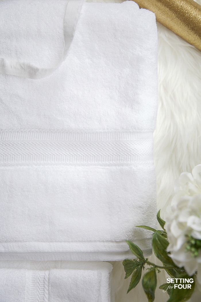 Gorgeous white towels with a beautiful border design to decorate a bathroom. #bathroom #towel #styling #ideas #spa