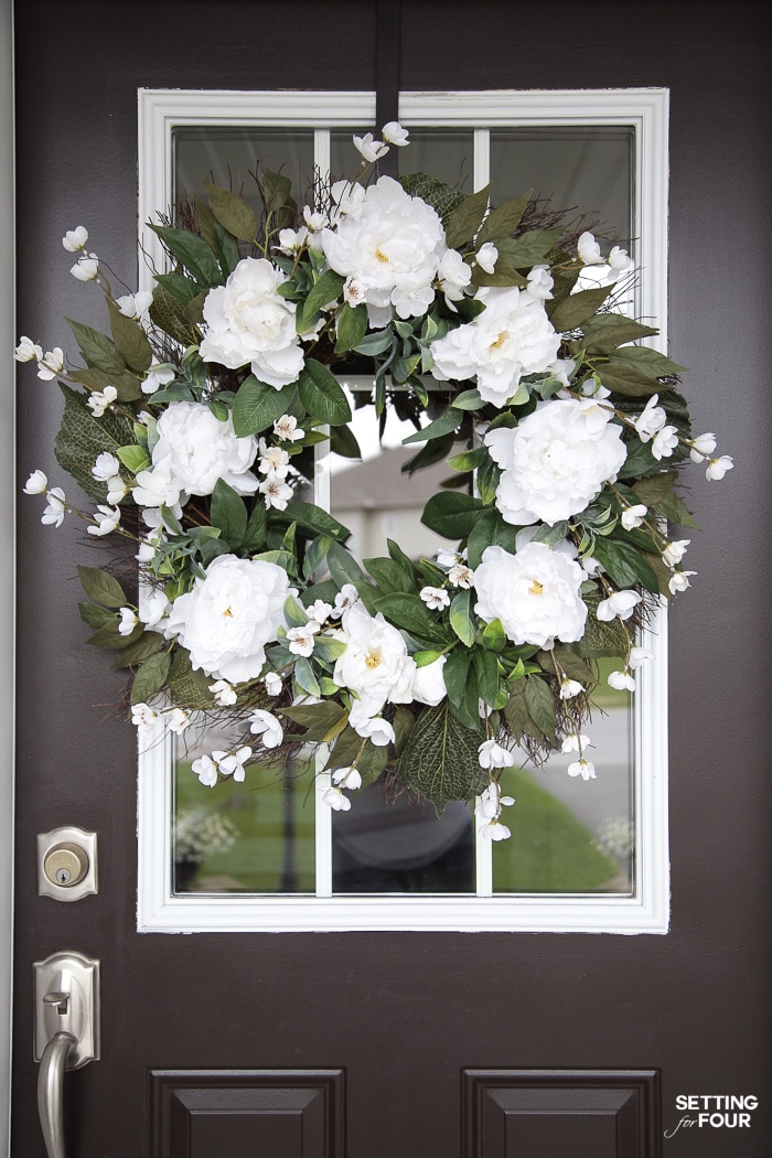 Farmhouse wreath on a front door.