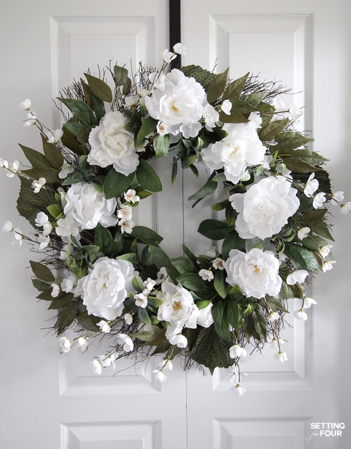 Peony floral wreath hung on a door.