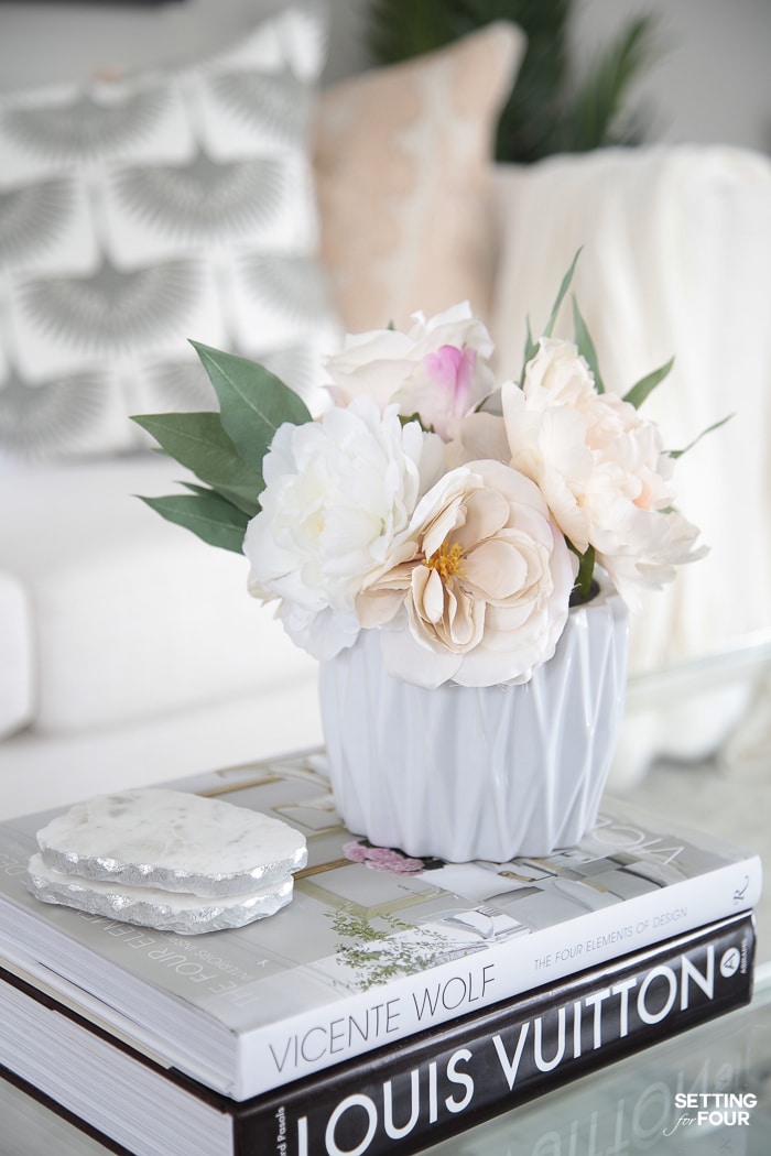 Simple coffee decor ideas. Bouquet of flowers in a vase on a stack of decor books.