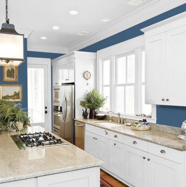 WHite kitchen with blue wall paint.