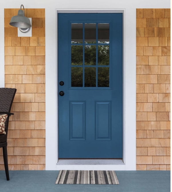 Blue front door color and blond wood shingles.