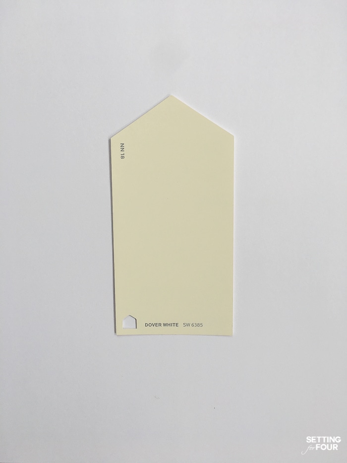 Sherwin Williams Dover White paint chip on a piece of printer paper.
