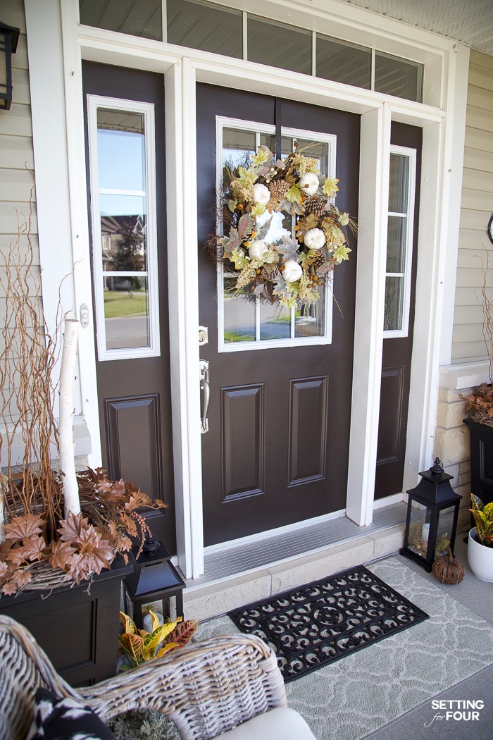 Fall decorated front door with layered door mats.