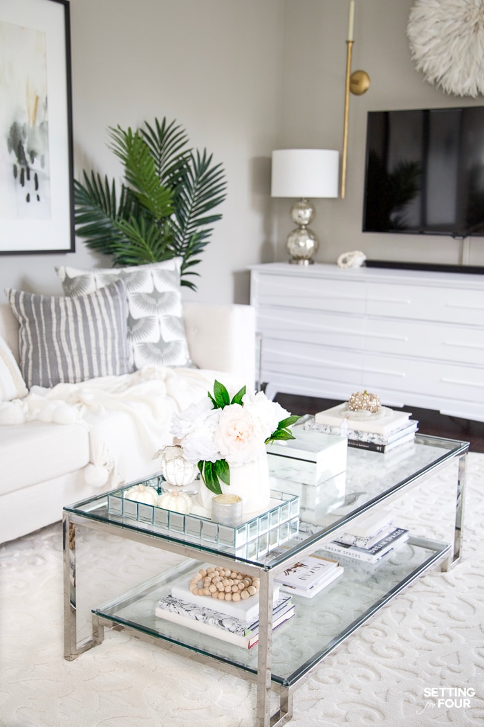 Fall styled coffee table decor with fall pumpkins and fall florals.