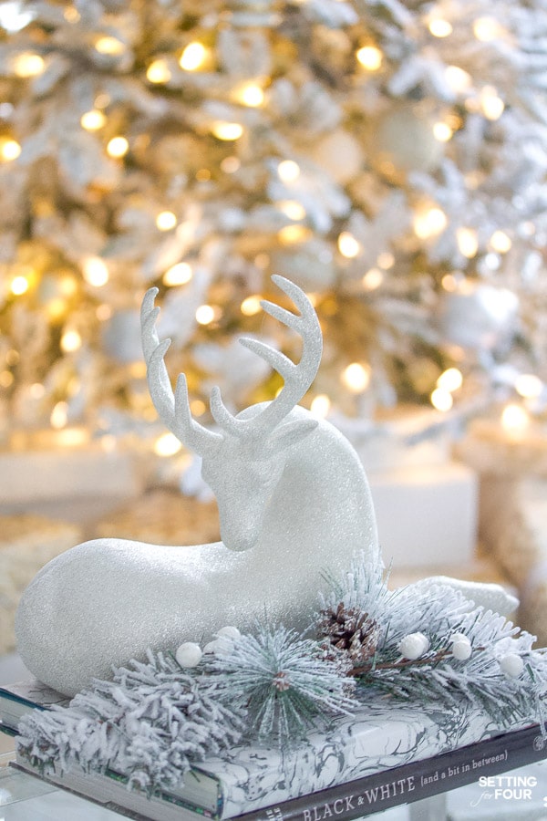 Christmas reindeer decor with pine garland on coffee table.