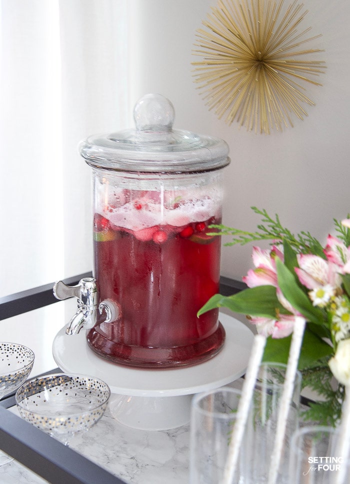 Holiday Sherbet punch recipe in a glass drink dispenser.