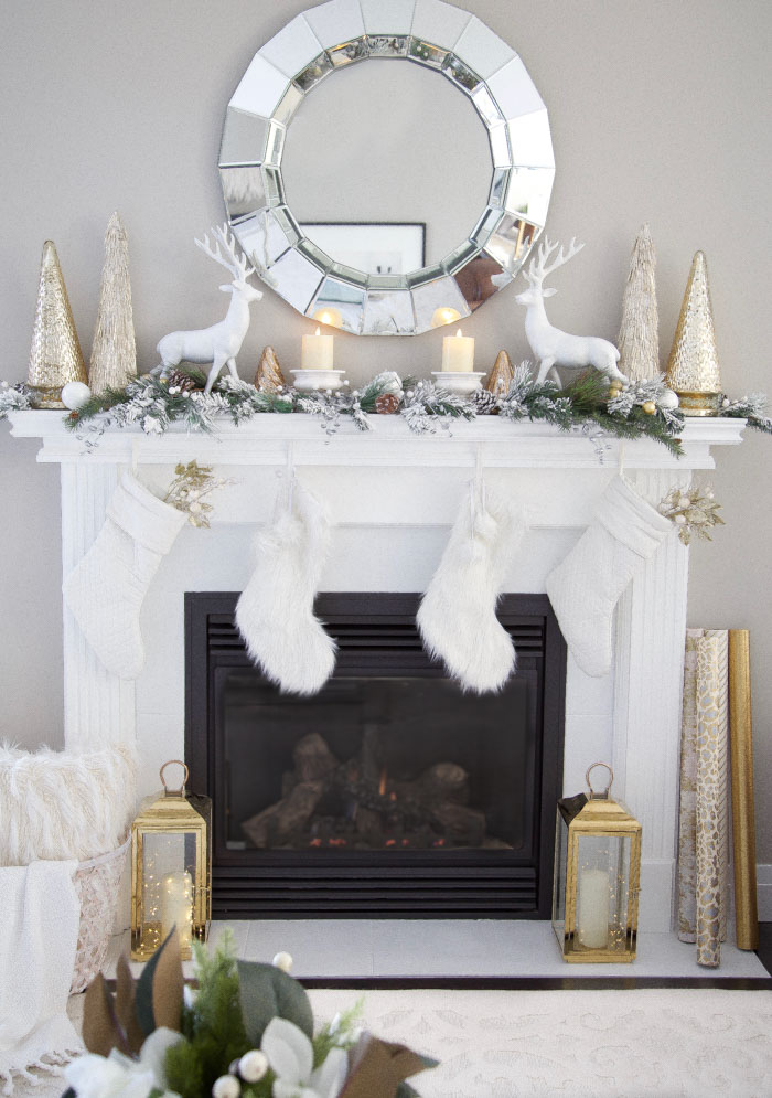 Gold and White Living Room Fireplace Mantel Decor Ideas with Christmas stockings, lanterns and string lights.