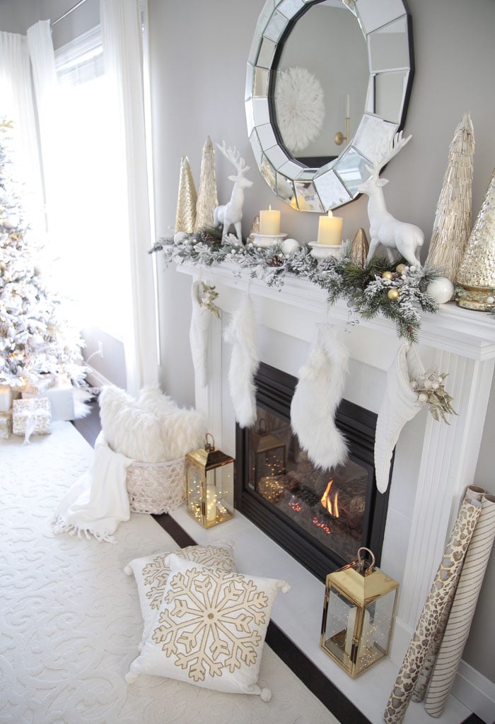 Gold and White Living Room Fireplace Mantel Decor Ideas with deer and glass Christmas trees.