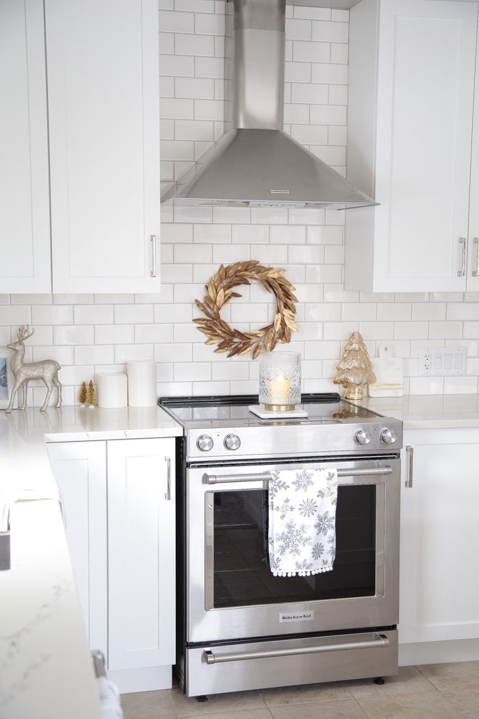 Christmas wreath over stove and holiday kitchen counter decor ideas.