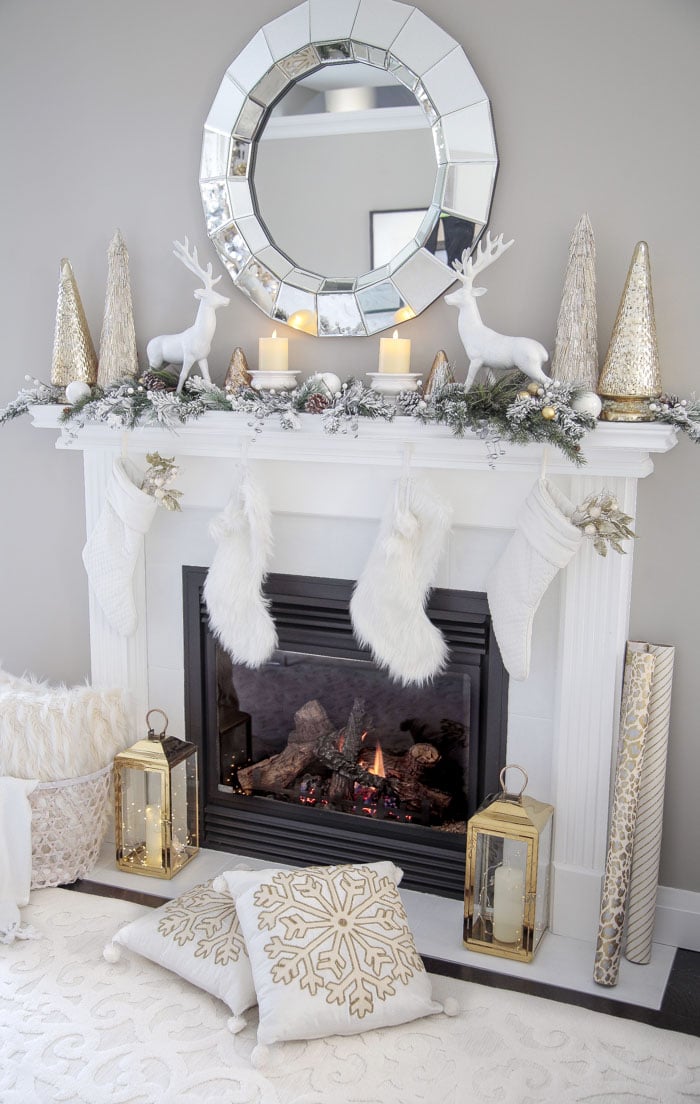 Gold and White Living Room Fireplace Mantel Decor Ideas with Christmas stockings, lanterns and fairy lights.