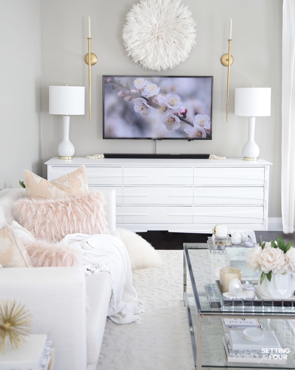 Living room design with TV unit, TV wall decor, white sofa, coffee table and Mindful Gray walls.