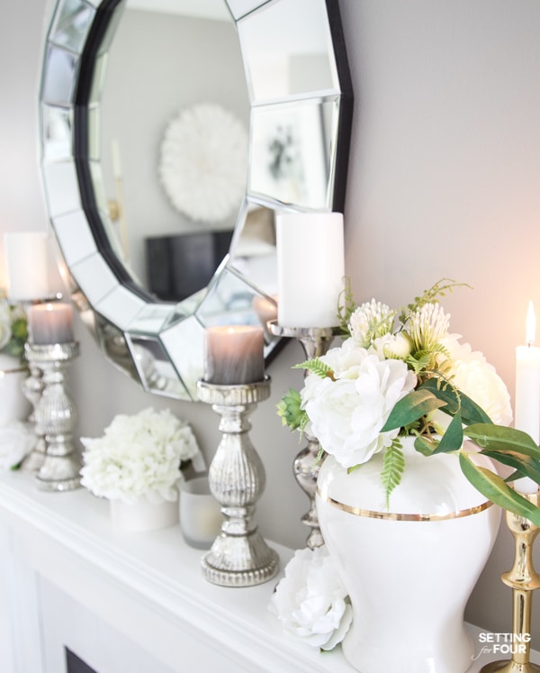 Summer Mantel Decorating Ideas with ginger jars, flowers, candle holders and white decor in living room. Sherwin Williams Mindful Gray paint color on walls