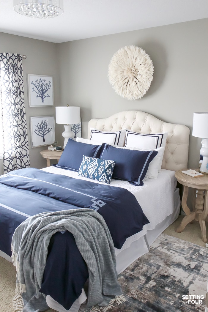 Beautiful modern glam blue and white bedroom with a cohesive look!