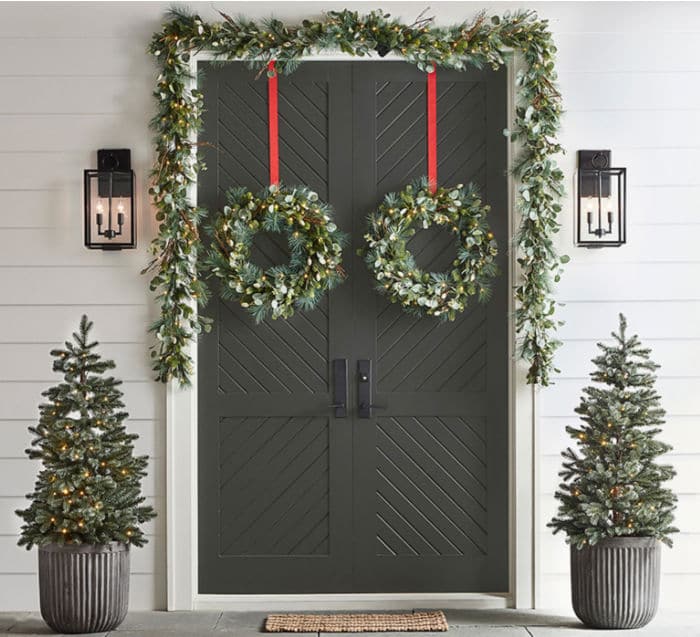 Spruce up your front porch with traditional wreaths, garland and trees trimmed with twinkling lights and red ribbons.