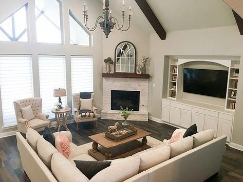 Open concept living room furniture arrangement with corner fireplace