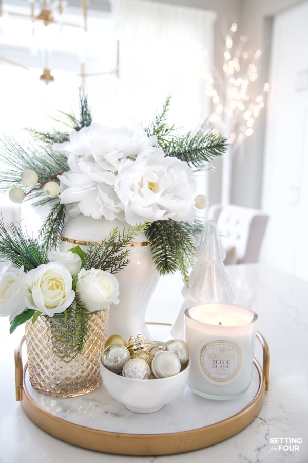 Beautiful Christmas Tray Decor Idea with flowers and greenery in a ginger jar and vase, tabletop Christmas tree, candles and bowl of ornaments.