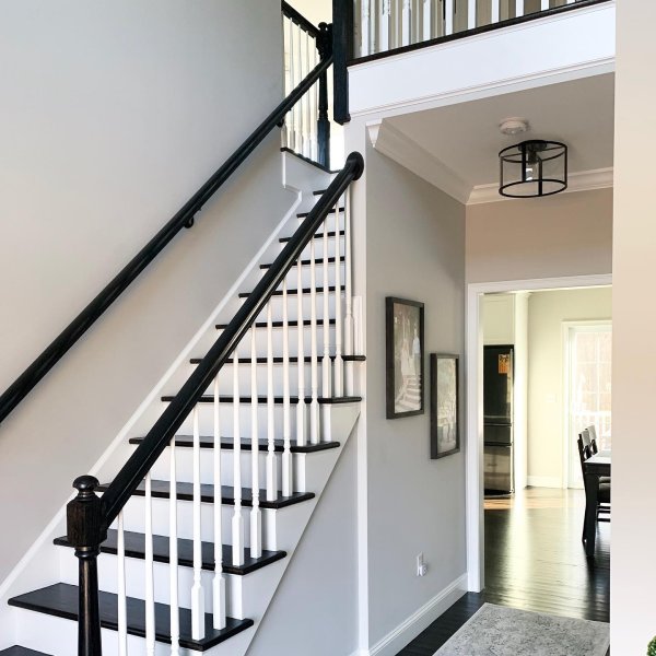 Sherwin Williams Repose Gray staircase wall paint color.