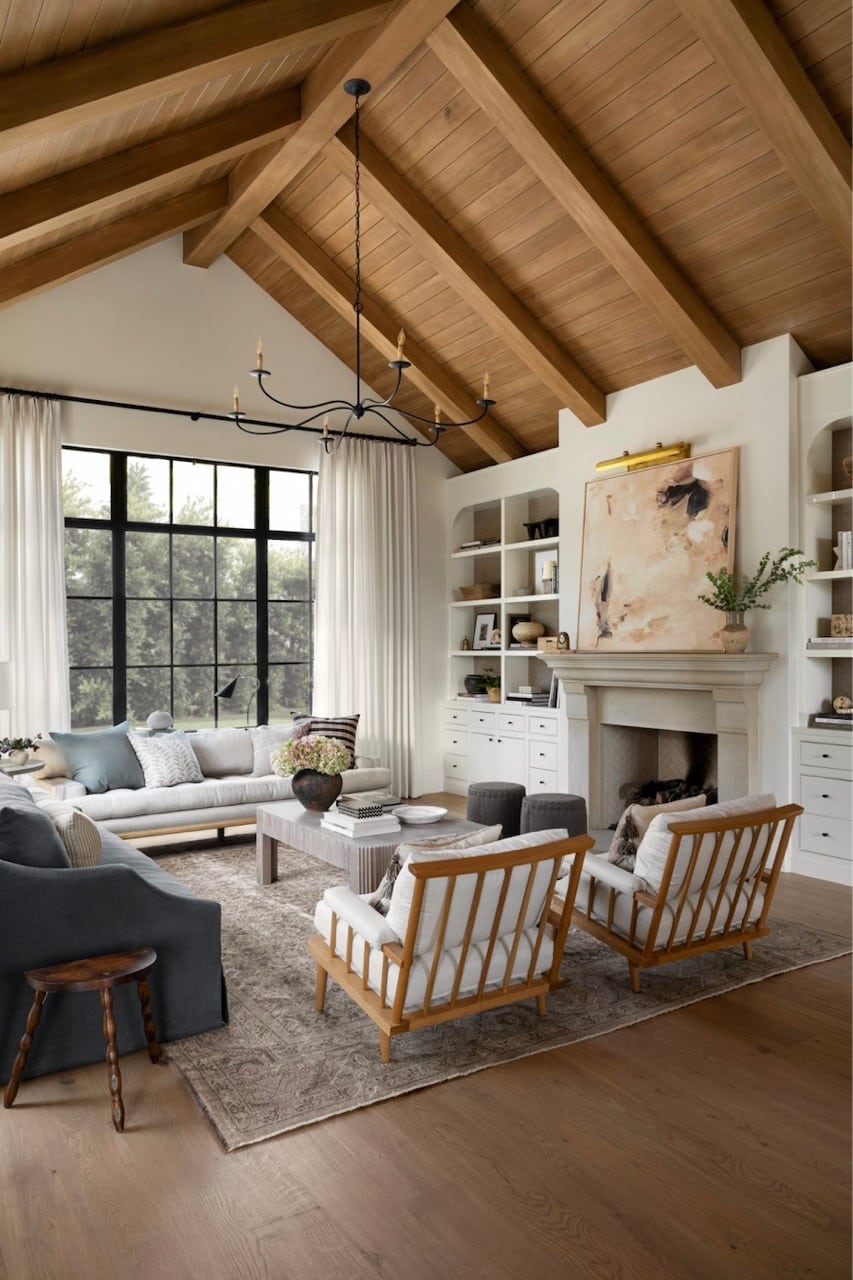 Cozy Long Living Room Furniture Arrangement Ideas, organic modern living room with vaulted ceiling, peaked ceiling, wood ceiling beams, 2 sofas and 2 chairs furniture layout, white wall color, Nancy Meyers style, 2026 trends, Pottery Barn aesthetic, neutral color scheme
