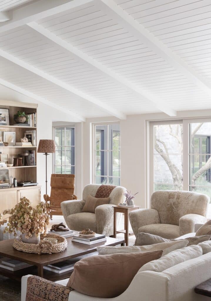 Cozy Living Room With Sofa and 2 Chairs, neutral color palette, earthy aesthetic, new home ideas, great room inspiration, furniture placement, wood shiplap vaulted ceiling with beams, coffee table decor, 2026 trends, interior design