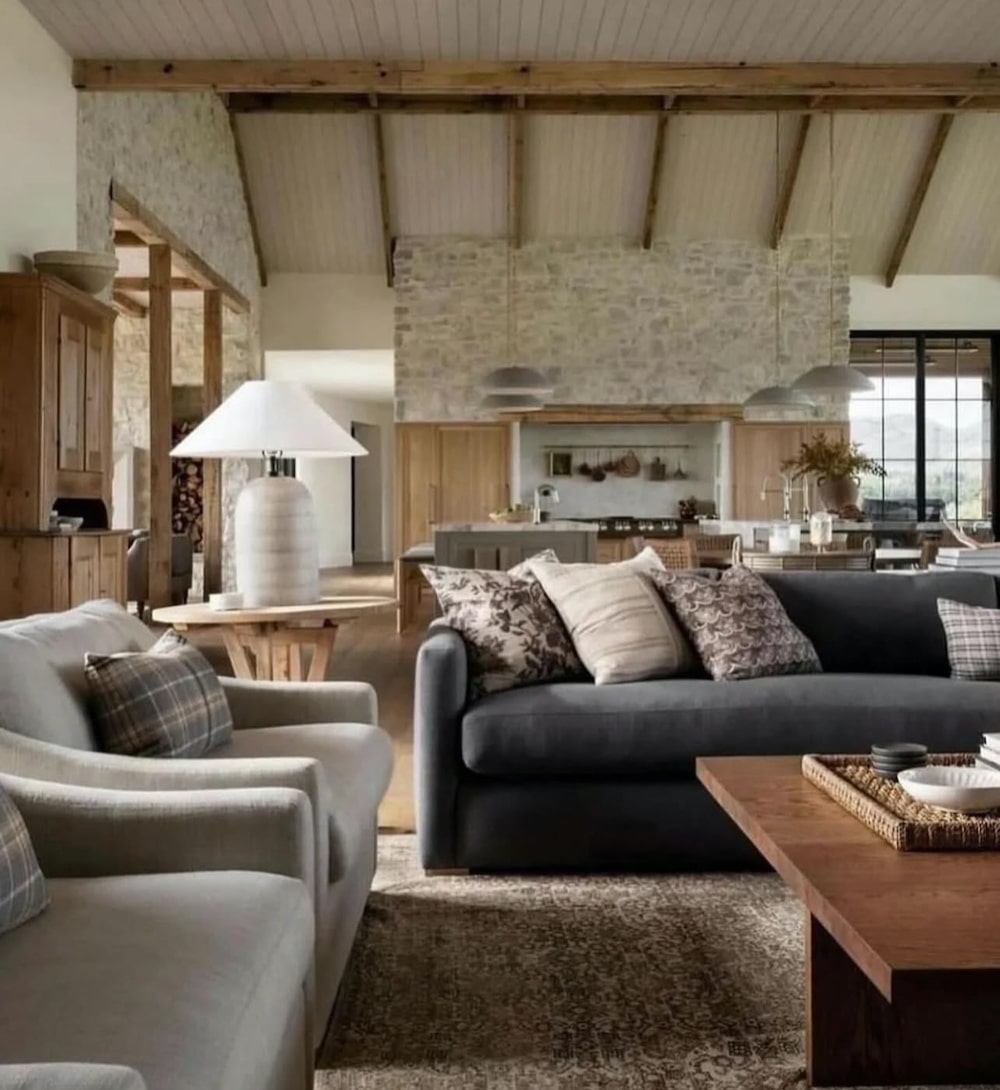 Open Concept Great Room Furniture Layout Ideas - Kitchen, Living Room and Dining Room, cozy, natural stone walls, wood beams on ceiling, modern, minimalist, transitional, sofa and 2 chairs, gray sofa, neutral color palette, earth tones, pillow mix, white, beige, black, 2026 trend