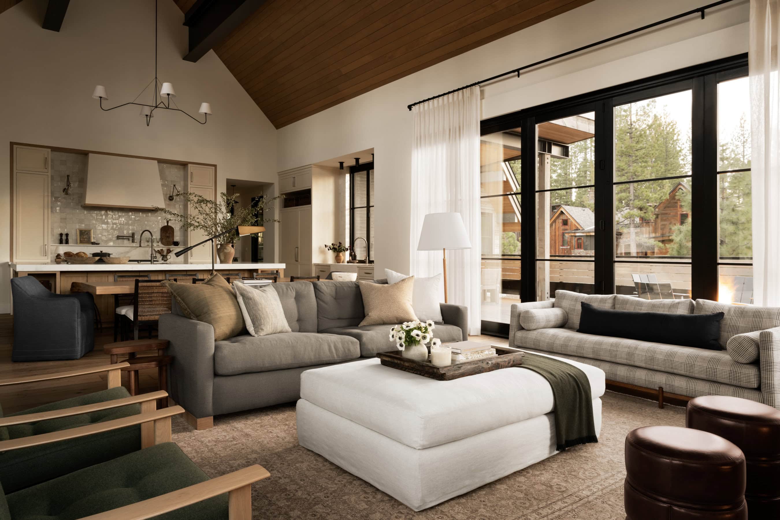 Moody, Earthy Living Room With 2 Sofas, 2 Chairs & Upholstered Ottoman Coffee Table Furniture Arrangement Idea, cozy, earth tone colors, cream wall color wood ceiling, gray sofa, gray chairs, black windows, how high to hang curtains above windows, modern, minimalist, natural, Studio McGee, Pottery Barn Style, 2025 and 2025 trends, new home ideas