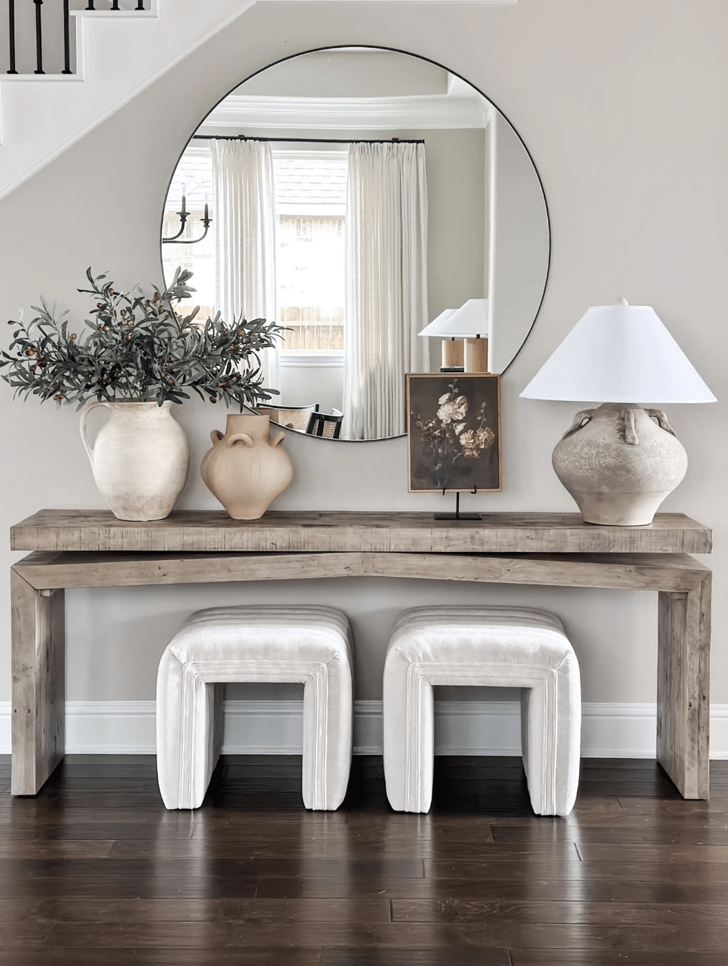 Sherwin Williams Repose Gray Entryway Paint Color Idea, greige wall color, wood console table with ottoman poufs, console table decor ideas, round mirror above console table, cozy, organic modern, transitional, farmhouse design inspiration, new home ideas, 2026 trends