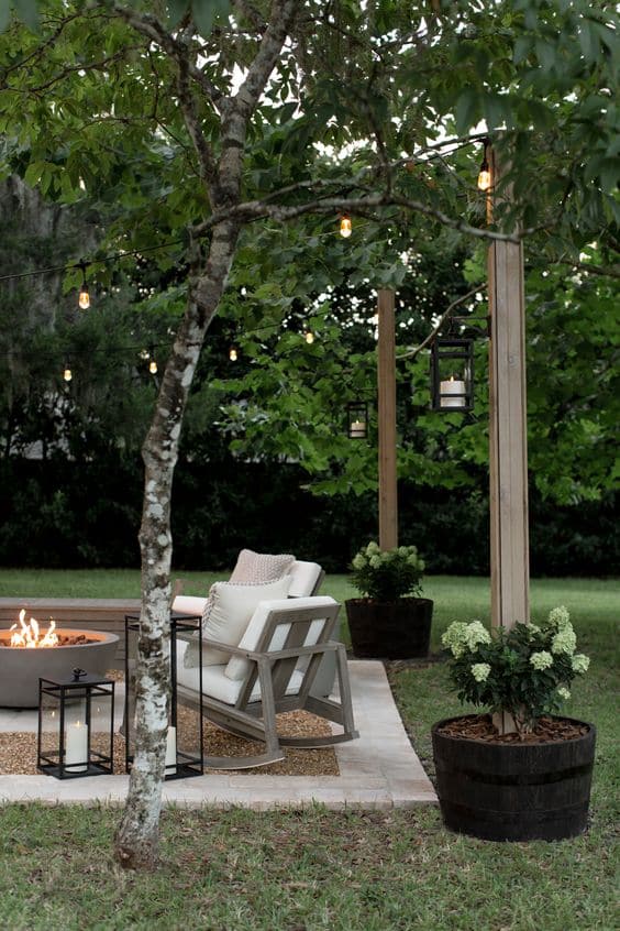 Easy and Cheap DIY Outdoor Lighting Idea. Patio makeover with backyard string lights and DIY planter posts to hang them.