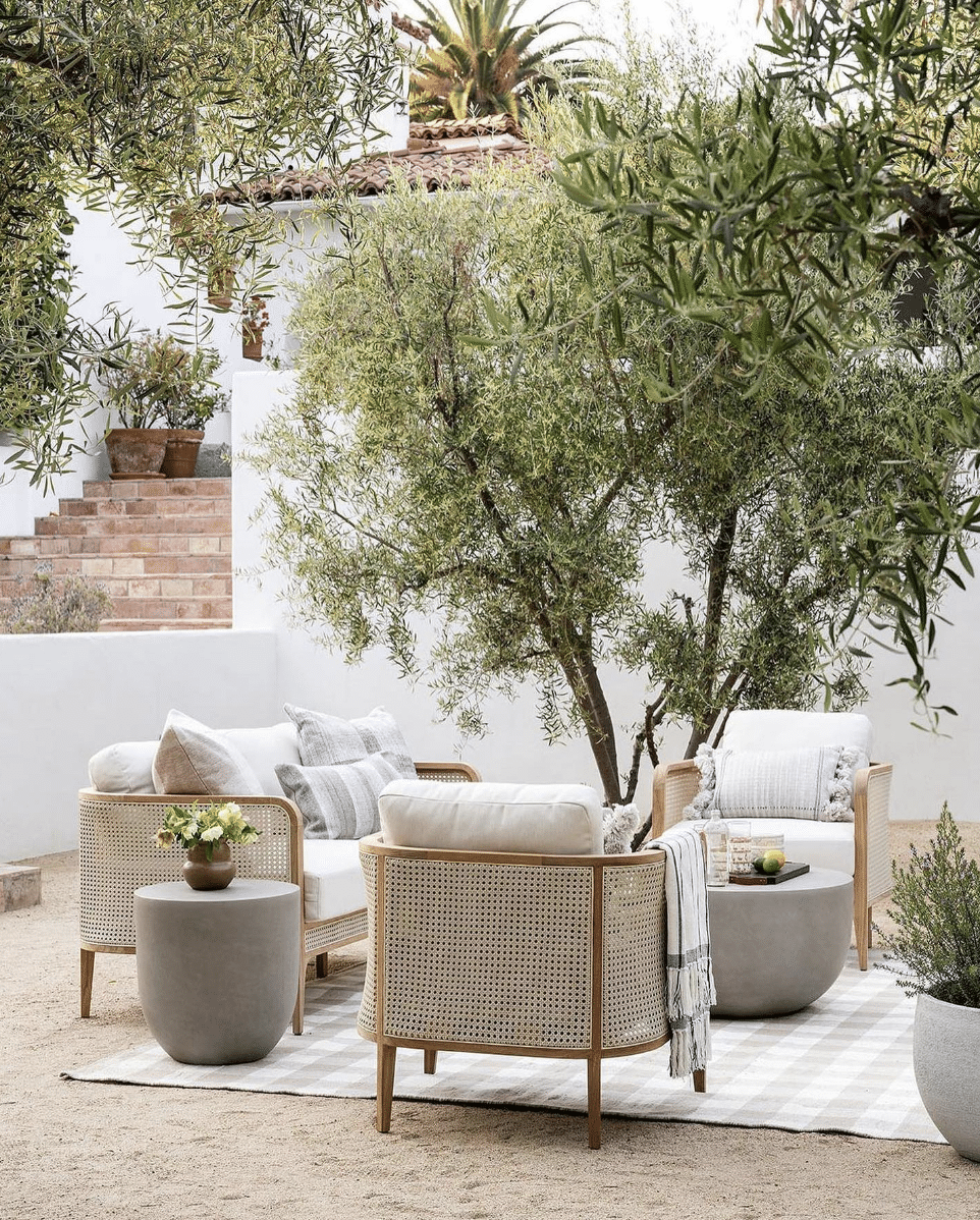  Beautiful Neutral Outdoor Patio Decor Ideas. Olive tree. outdoor rug, outdoor furniture. rattan.