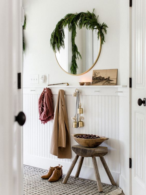 Small Entryway Ideas - Decor , Design and Storage Ideas with wall hooks and board and batten wall treatment, round mirror and bench.