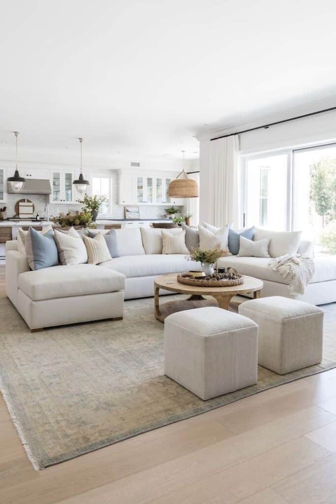 Neutral Living Room Design Ideas
Elegant living room, neutral, airy, bright, sectional sofa, round coffee table, pouf ottomans, design and decor ideas