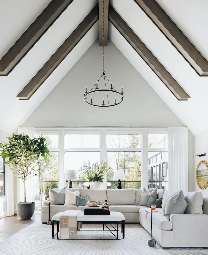 How to pick paint colors for the whole house. Whole home color palette tips from a Designer and True Color Expert! White livng room walls with wood beams and modern farmhouse design.