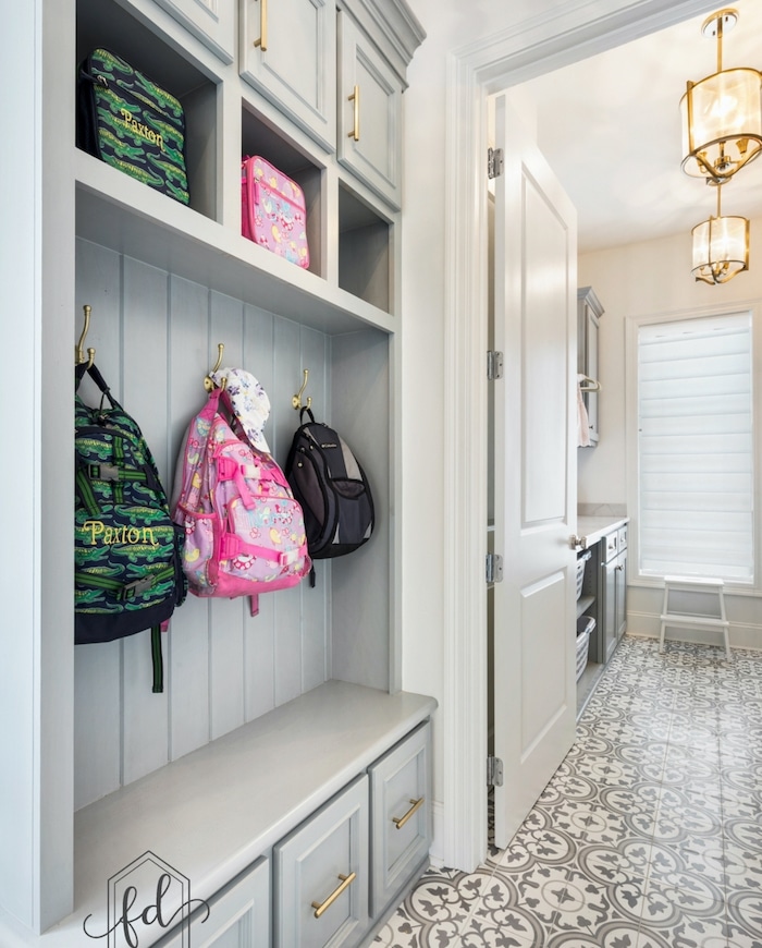 Mudroom bench with storage and hooks. Open cubbies, hooks for backpack, closed cabinets and a bench for beautiful mudroom organization.