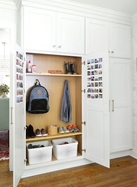Mudroom built in shoe storage and backpack storage idea. Built in locker cabinets. White shaker cabinets with doors hide all the clutter and keep backpacks off the floor and out of sight.
