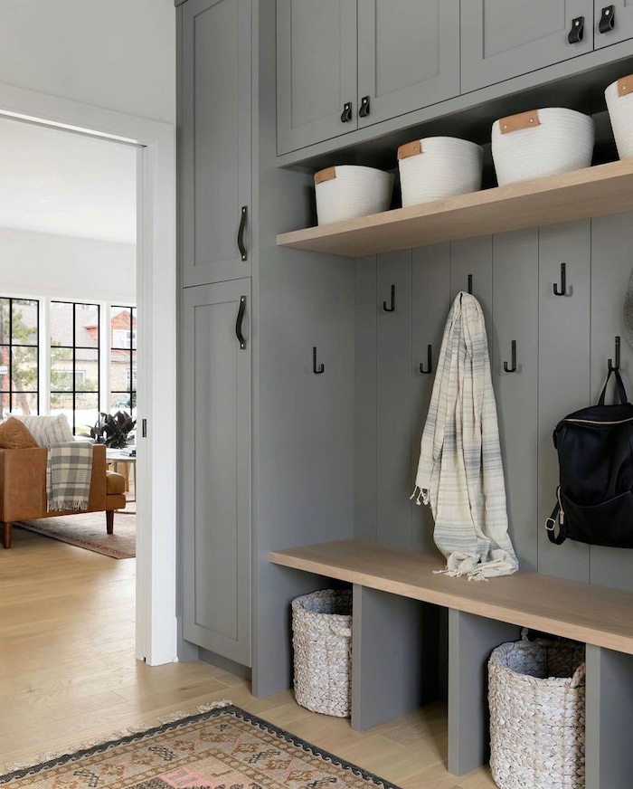 Mudroom Cabinetry Organization and Decor Ideas. Beautiful built in cabinets with hooks to store backpacks, baskets and closed doors to organize coats and shoes.