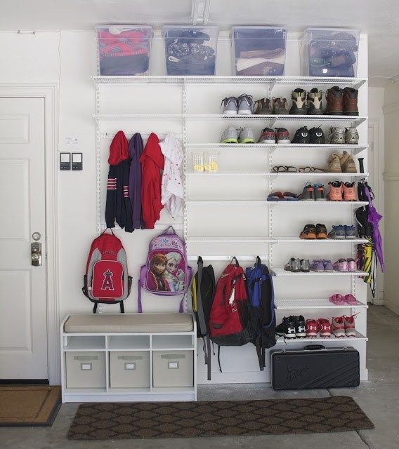 Backpack Storage Ideas In a Garage. Have no entryway or mudroom? Store backpacks and coats in the garage with this white shelving system!