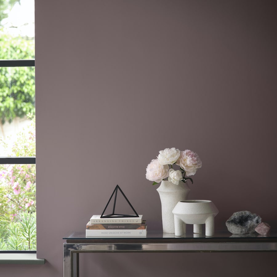 Benjamin Moore Cinnamon Slate Transitional Living Room Paint Color Idea. console table with vase,, decor and books, purple color palette, color of the year 2025, plum, brown, cozy, elegant, wall color, painting inspiration, 2025 design trends, modern, neutral.