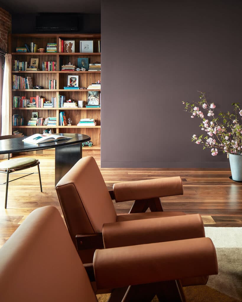 Benjamin Moore Cinnamon Slate Modern Living Room Paint Color Inspiration.  brown arm chairs, wood floors, builtin bookshelf, den, rich, luxurious, purple, plum,  cozy color palette, color of the year 2025, cozy, elegant, wall color, painting inspiration, 2025 design trends, true color expert tips, designer look.