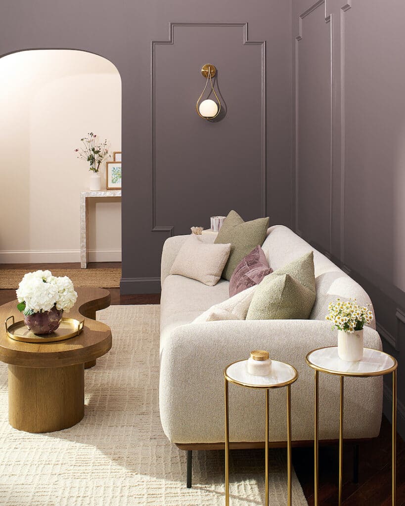 Benjamin Moore Cinnamon Slate Modern Living Room Paint Color Inspiration. neutral sofa with brown wood coffee table and nesting end tables, rich, luxurious, purple, plum,  cozy color palette, color of the year 2025, cozy, elegant, wall color, painting inspiration, 2025 design trends, transitional interior design, neutral.