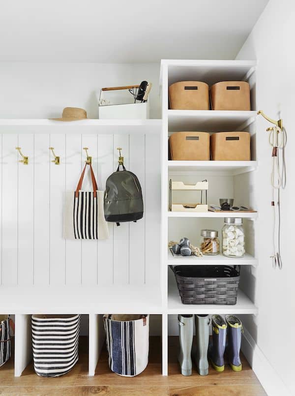 Mudroom Built In Cabinets With Bench and Cubbies. Wall hooks on vertical shiplap store back packs and purses. Letter tray to organize papers, clear canisters store dog treats.