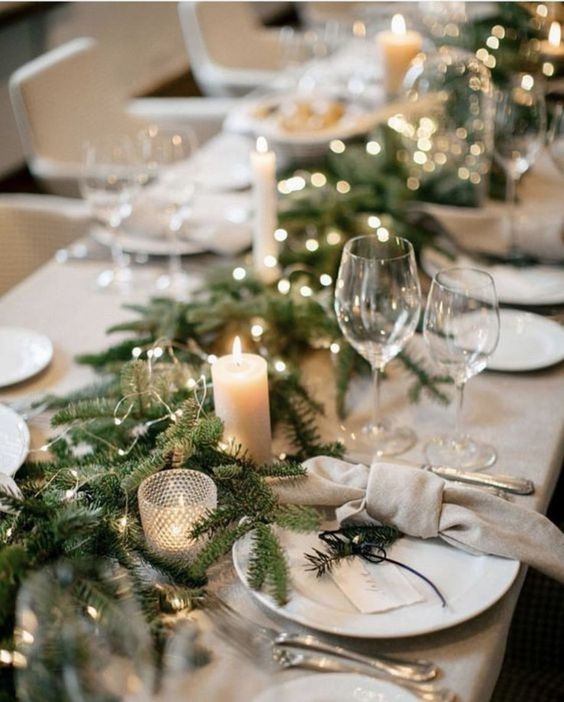 Neutral, Simple Christmas Decorating Ideas. Easy holiday tablescape and centerpiece ideas with candles, twinkle lights, garland and beige tablecloth. Simple place cards at each table setting.