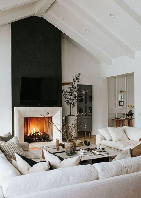 Modern Living Room With Black Fireplace Wall and Furniture Layout Idea. white walls, fireplace design, minimalist, organic modern, transitional, farmhouse, simple, color palette, color scheme ideas.
