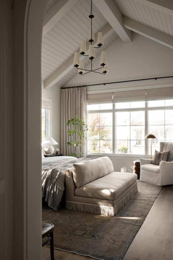 Neutral Bedroom Decor and Design Ideas. how to pick a bedroom rug, bedroom rug size tips, color scheme, cozy, classy, modern, transitional, farmhouse, minimalist, black curtain rod with neutral curtains, sofa at end of bed, bedroom decor ideas