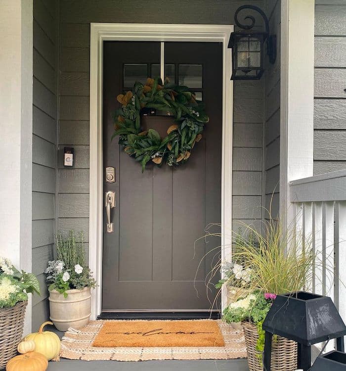 Sherwin Williams Urbane Bronze Front Door Paint Color Idea. earthy, neutral, cozy front porch decor inspiration, planter ideas, fall decorating, magnolia front door wreath, farmhouse, traditional, cottage home exterior design ideas.
