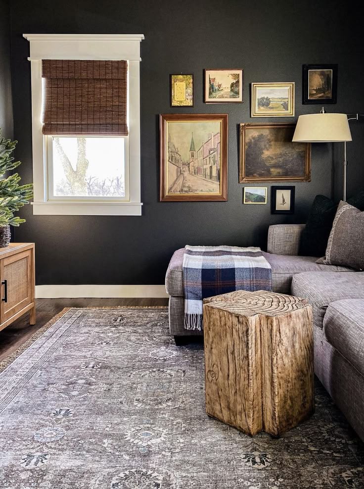 Sherwin Williams Urbane Bronze Living Room Wall Paint Color Inspiration with a sectional sofa, small coffee table, vintage wall art, tv unit and woven shade for windows . earthy, moody, dark brown, cozy, elegant, modern, transitional, traditional, design style ideas.