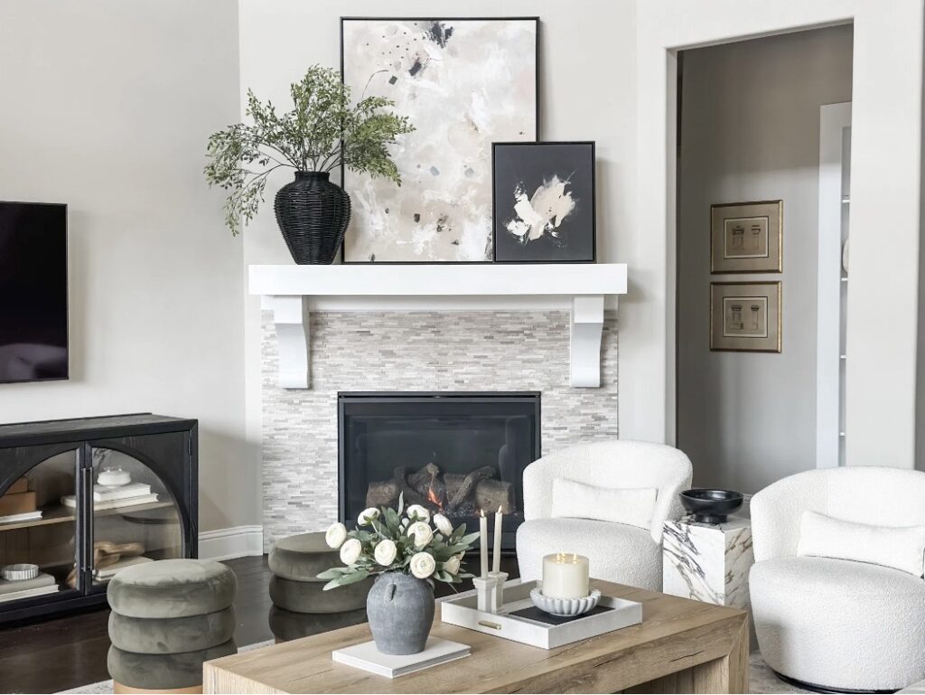Corner Fireplace Furniture Arrangement Idea with a TV and TV unit, art above fireplace, sofa and two chairs furniture placement, room layout neutral color palette, Sherwin Williams repose gray, modern, transitional, cozy home ideas, awkward room ideas, design tips, 2026 trends
