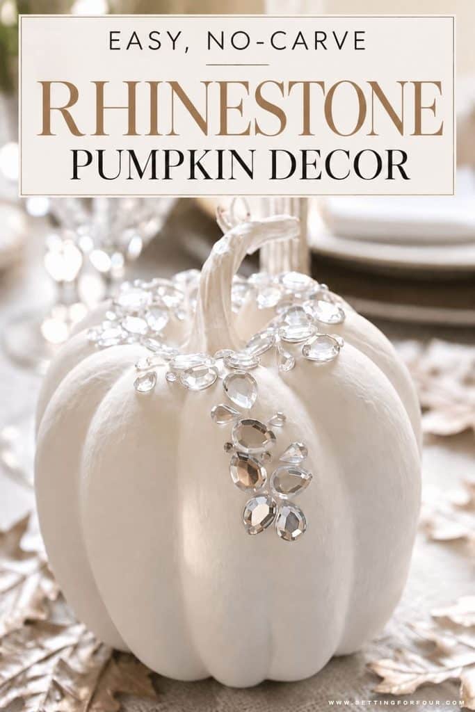 Pinterest graphic featuring an elegant white painted faux pumpkin embellished with cascading clear rhinestones around the stem. The pumpkin is displayed on a neutral fall tablescape with metallic leaves, crystal glassware and soft natural lighting