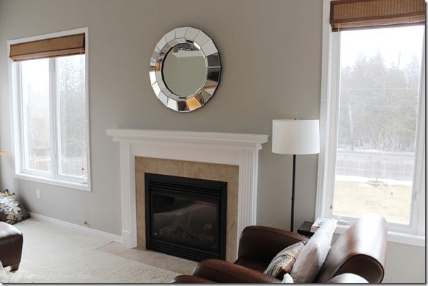 You won't believe what a difference paint can make! See this painted fireplace mantel before and after and how a dated honey-oak wood mantel was transformed with white paint. Get the easy DIY tutorial, paint color, supply list and designer tips for updating an outdated fireplace mantel.