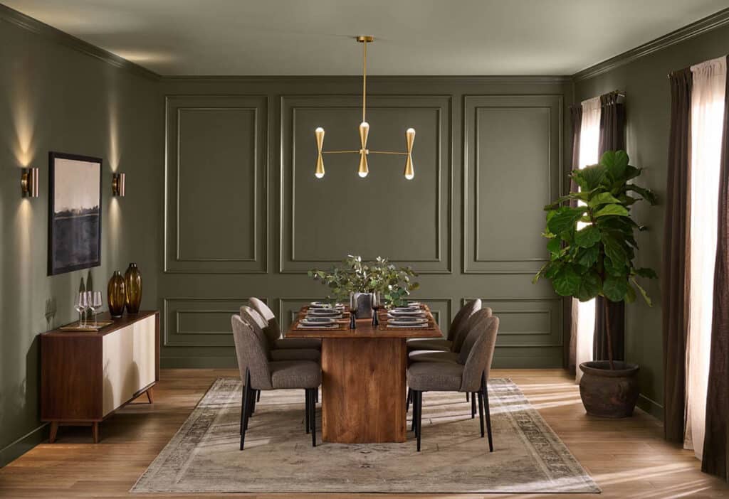 Behr Grounded Dining Room Paint Color Idea, green dining room with wall molding, wood dining table and statement brass chandelier, cozy, earthy paint color inspo