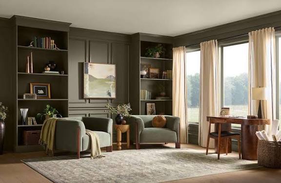 Behr Grounded Office Paint Color Idea, green wall color with green bookcases, green club chairs and wood desk, cozy home office inspiration, 2027 design trends